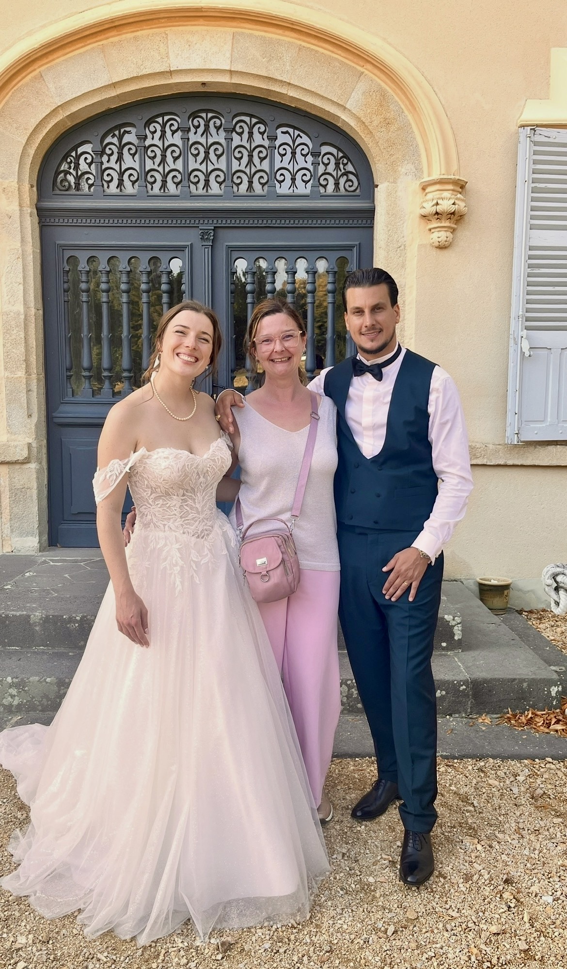 Les mariés souriants devant la porte du Château de la Reynerie, mariage animé par Stephevent63